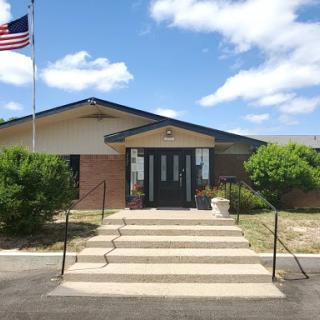 A building featuring an American flag, showcasing a welcoming entrance.