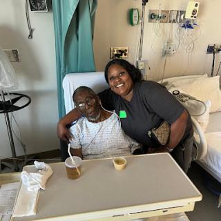 A joyful moment shared between a patient and their caregiver during hospital recovery.