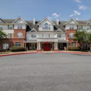 A large residential building with a symmetrical facade and entrance.