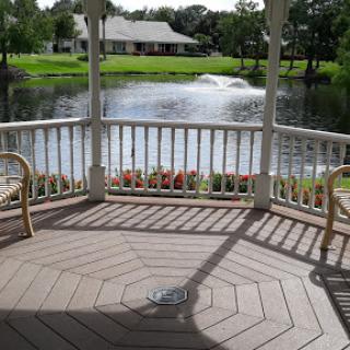 A serene view from a gazebo overlooking a peaceful pond.