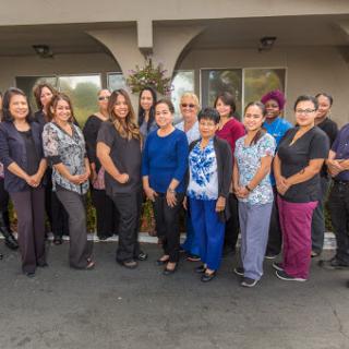 Team gathering featuring a diverse group of women in a professional setting.