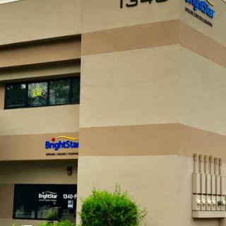 A commercial building featuring large windows and prominent signage.