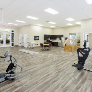A spacious and modern fitness area equipped with various exercise machines.