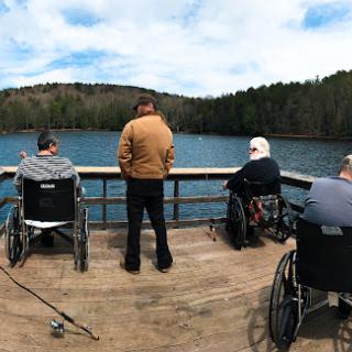A group of individuals enjoying a peaceful day by the lake.
