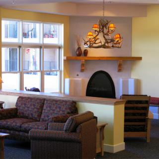 A cozy living room with comfortable seating and a warm fireplace.