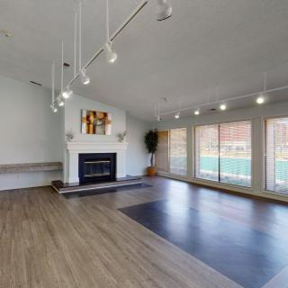 Spacious living room with large windows and modern lighting.