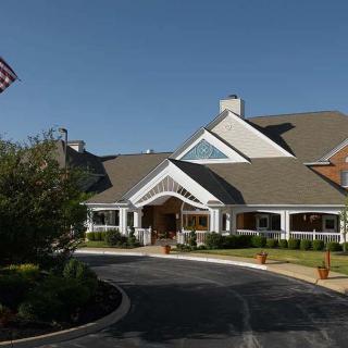 A large residential building with a driveway and flag.