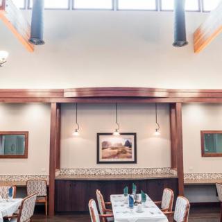 A well-lit restaurant interior featuring neatly arranged tables and elegant decor.
