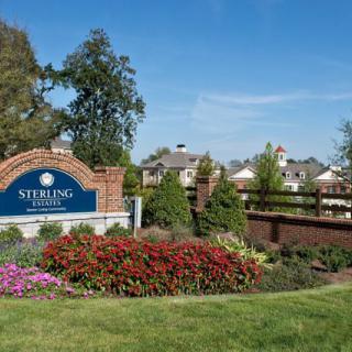Entrance to the Sterling residential housing complex surrounded by landscaped gardens.