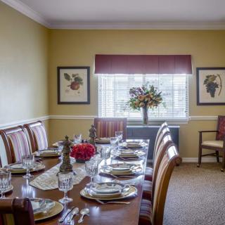 A well-decorated dining room with an elegantly set table ready for a meal.