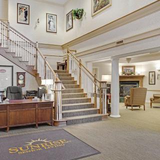 A welcoming lobby with a staircase, reception desk, and comfortable seating area.