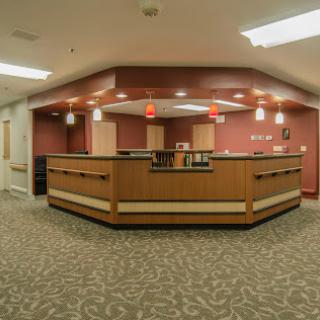 A modern reception area with warm lighting and stylish furniture.