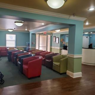 A spacious lobby with colorful chairs and bright lighting.