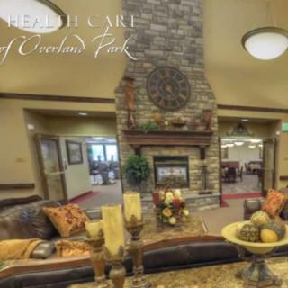 A cozy living room interior with a stone fireplace and decorative furnishings.