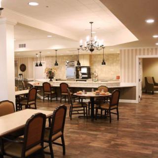 A cozy dining area with elegant lighting and wooden floors.