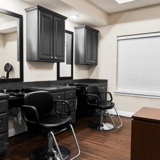 A modern hair salon interior with styling chairs and mirrors.