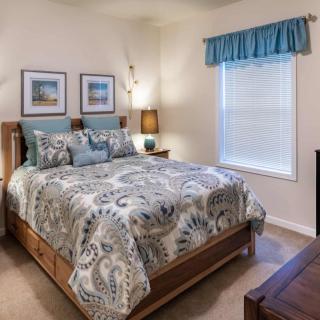 A cozy bedroom with patterned bedding and stylish decor.