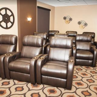A cozy home theater with comfortable recliner seating.