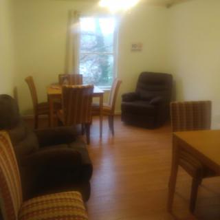 A cozy living room with a dining table and comfortable seating.