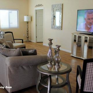 A cozy living room with modern decor and a large TV.