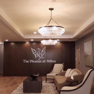 A stylish lobby with elegant chandeliers and comfortable seating at The Phoenix at Milton.