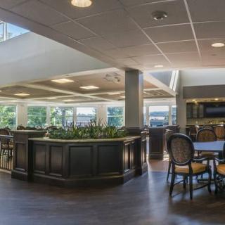 A spacious lounge area with ample seating and natural lighting.