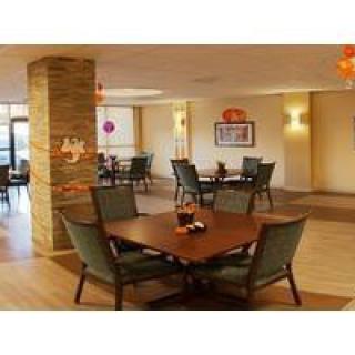 A modern restaurant interior with elegant dining tables and chairs.