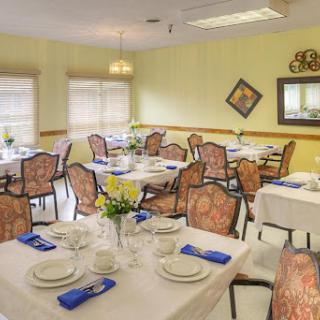 A beautifully arranged dining area with elegantly set tables and a cozy atmosphere.