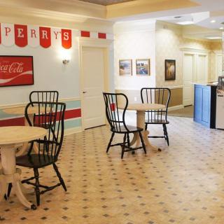Cozy retro-style cafe interior with tables and chairs.