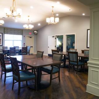 Elegant dining area with wooden floors and modern lighting.