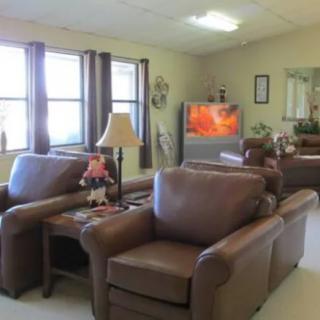 A cozy living room with leather sofas and a television.