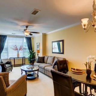A cozy living room with comfortable seating, elegant lighting, and tasteful decor.