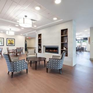 A modern and spacious lobby with comfortable seating and a fireplace.