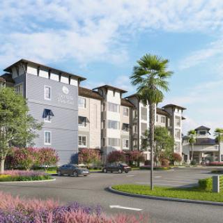 A modern residential complex surrounded by lush landscaping.