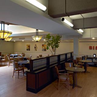 An empty restaurant interior with tables and chairs neatly arranged.