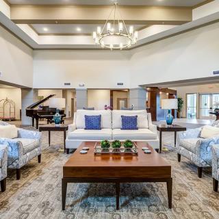 A luxurious living room featuring modern interior design with elegant furniture and a grand chandelier.