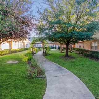 A landscaped garden with a winding pathway in an apartment complex.