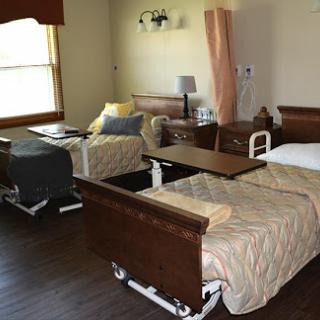 A view of a hospital room featuring two patient beds, suitable for medical care and comfort.