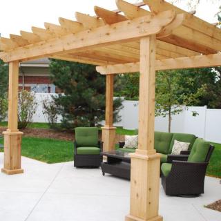 Outdoor patio with a wooden pergola and comfortable seating.