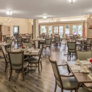 A spacious and elegantly decorated dining area with neatly arranged tables and chairs.
