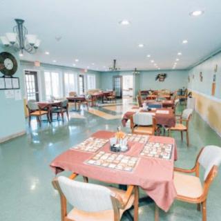 A spacious dining area with tables and chairs arranged neatly.