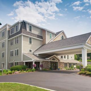 A modern hotel building with a welcoming entrance and landscaped surroundings.