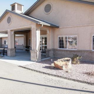 Front view of a building entrance with a driveway, captured during the daytime.