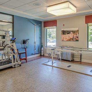 A rehabilitation room equipped with exercise machines and physical therapy tools.