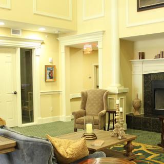 A cozy living room with elegant furniture and a warm fireplace.