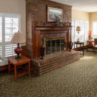 A cozy living room featuring a brick fireplace and comfortable furnishings.