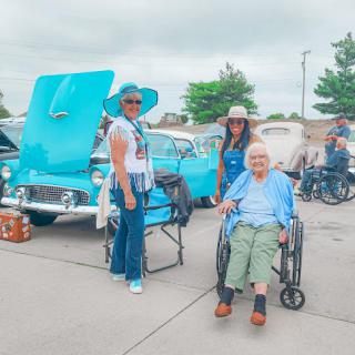 Enjoying a vibrant car show with family and friends.