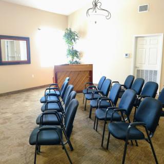 A clean and organized waiting room with blue chairs and a welcoming atmosphere.