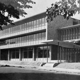 A black and white photo of a modernist building, showcasing mid-20th century architectural style.