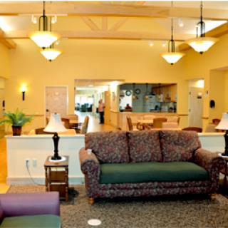 A cozy living room with elegant lighting and comfortable seating arrangements.